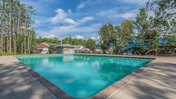 Relax by the pool surrounded by lush greenery.