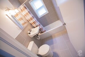 Combined shower/bathtub, towels, soap, toilet paper