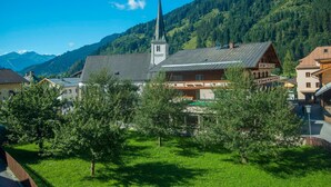 A town with a church, a wooden building, and a mountain backdrop.