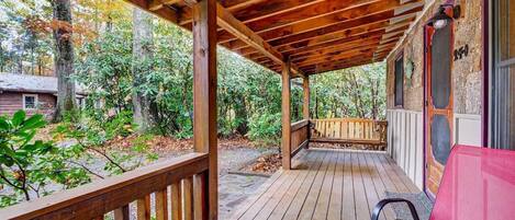 A wooden deck with a bench and a door marked "241".