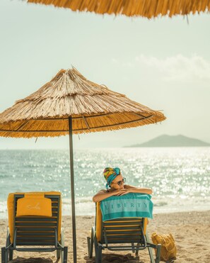 On the beach, sun-loungers, beach umbrellas, beach towels