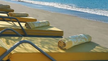 On the beach, sun-loungers, beach umbrellas, beach towels