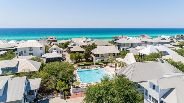 Ein Küstenresort mit Schwimmbad, umgeben von Villen und mit Blick auf den Ozean.