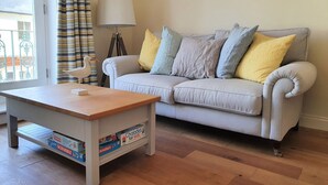 Ein Wohnzimmer mit einer Couch, einem Couchtisch und einer Lampe.