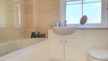 Combined shower/bathtub, hair dryer, towels, soap