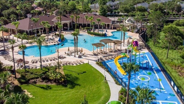 A resort with multiple swimming pools, a water park, and a well-maintained lawn area. - Lakefront Windsor Hills - 6 Bed 4 Bath Home with Custom Mickey Mouse Heated Pool (Kissimmee)