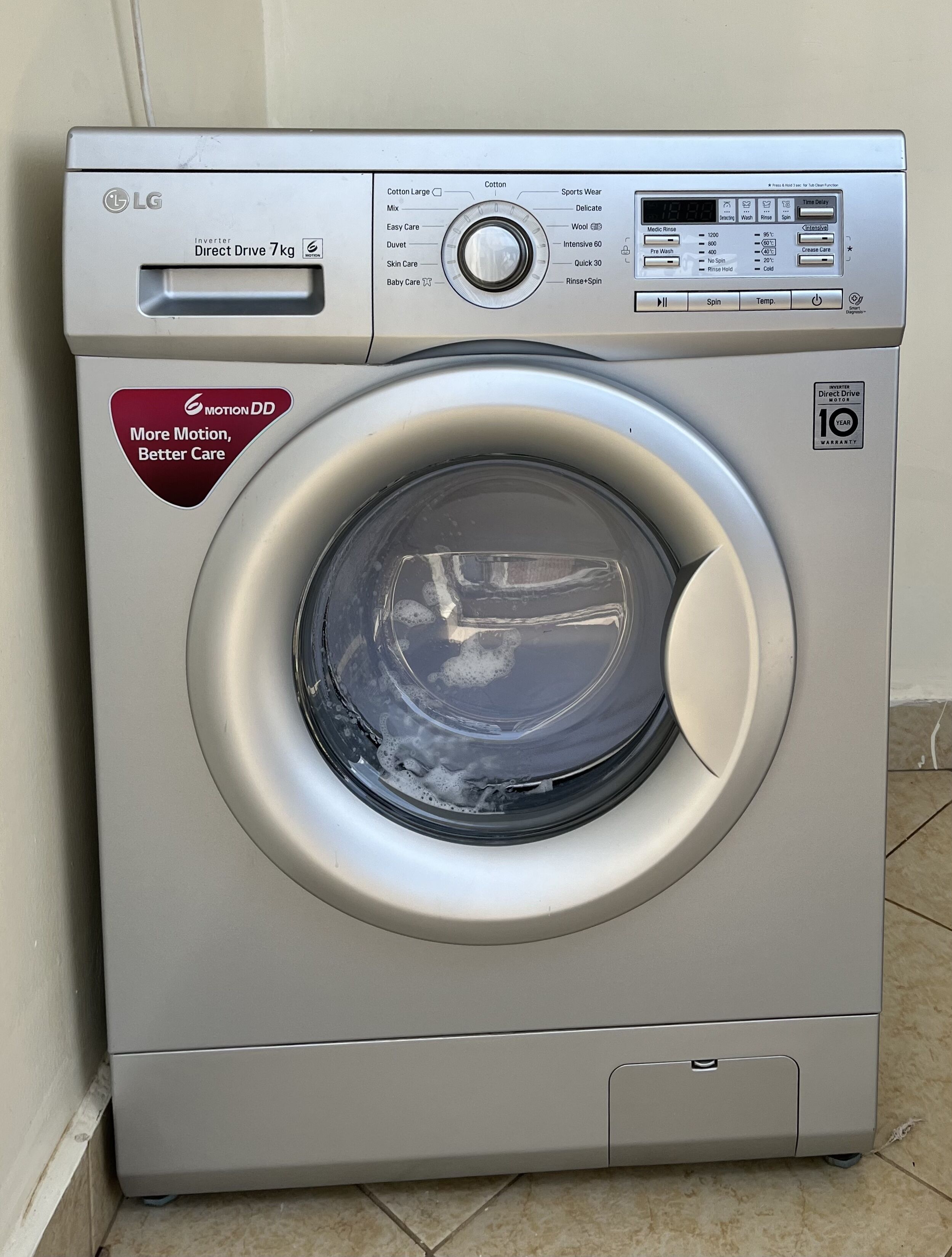 A front view of an LG inverter direct drive 7kg washing machine with a 10-year warranty.