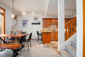 A modern kitchen with wooden cabinets, a built-in oven, and a countertop with a sink. - 2BR | Symphony | Dog Friendly | Hot Tub | Private Balconies | Village Location | Parking (Whistler)