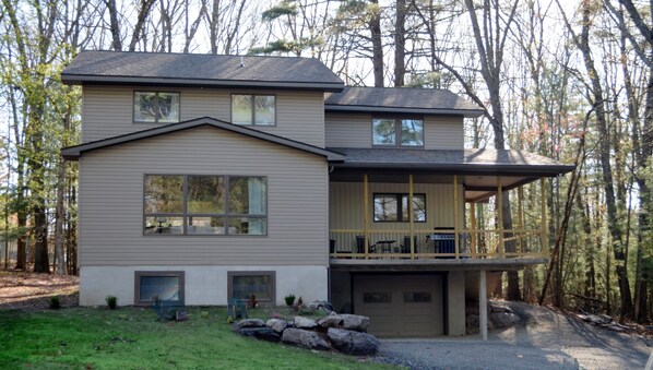 A two-story house with a covered porch and a garage.