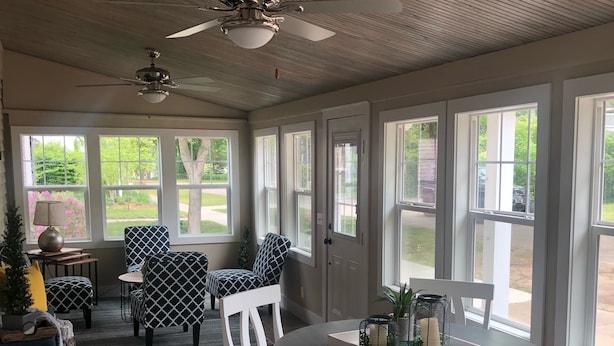 A spacious room with a large dining table, white chairs, and a ceiling fan. - Sparkling Home in Saugatuck area! (Douglas)