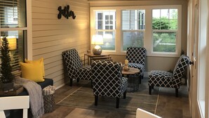 A cozy room with a ceiling fan, a table with chairs, and a window with blinds. - Sparkling Home in Saugatuck area! (Douglas)