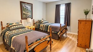 A room with two wooden beds, a wooden cabinet, and a painting on the wall. - The Forest Lodge-Spacious 3BR Farm Barndo with Fire Pit on a working horse farm (White Hall)