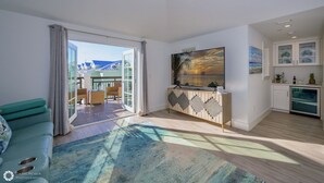 Ein modernes Wohnzimmer mit Sofa, Essbereich und Küche.