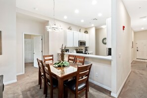 Enjoy meals in the spacious kitchen and dining area, featuring a central island and seating for six.