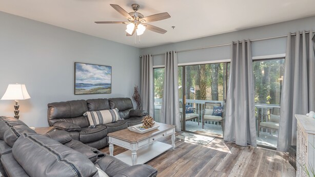 A living room with a sectional sofa, a coffee table, and a ceiling fan. - Gorgeous Clean 3 Bdrm, 2 Owner Suites, South Forest Beach, near beach and pool! (Hilton Head Island)