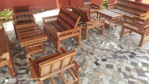 A patio area with wicker furniture and a mosaic tile floor. - Lagoon Residence Appt Bioguera (Porto-Novo)