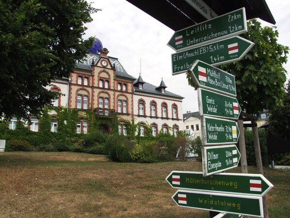 A directional signpost with multiple arrows pointing to various destinations and distances.