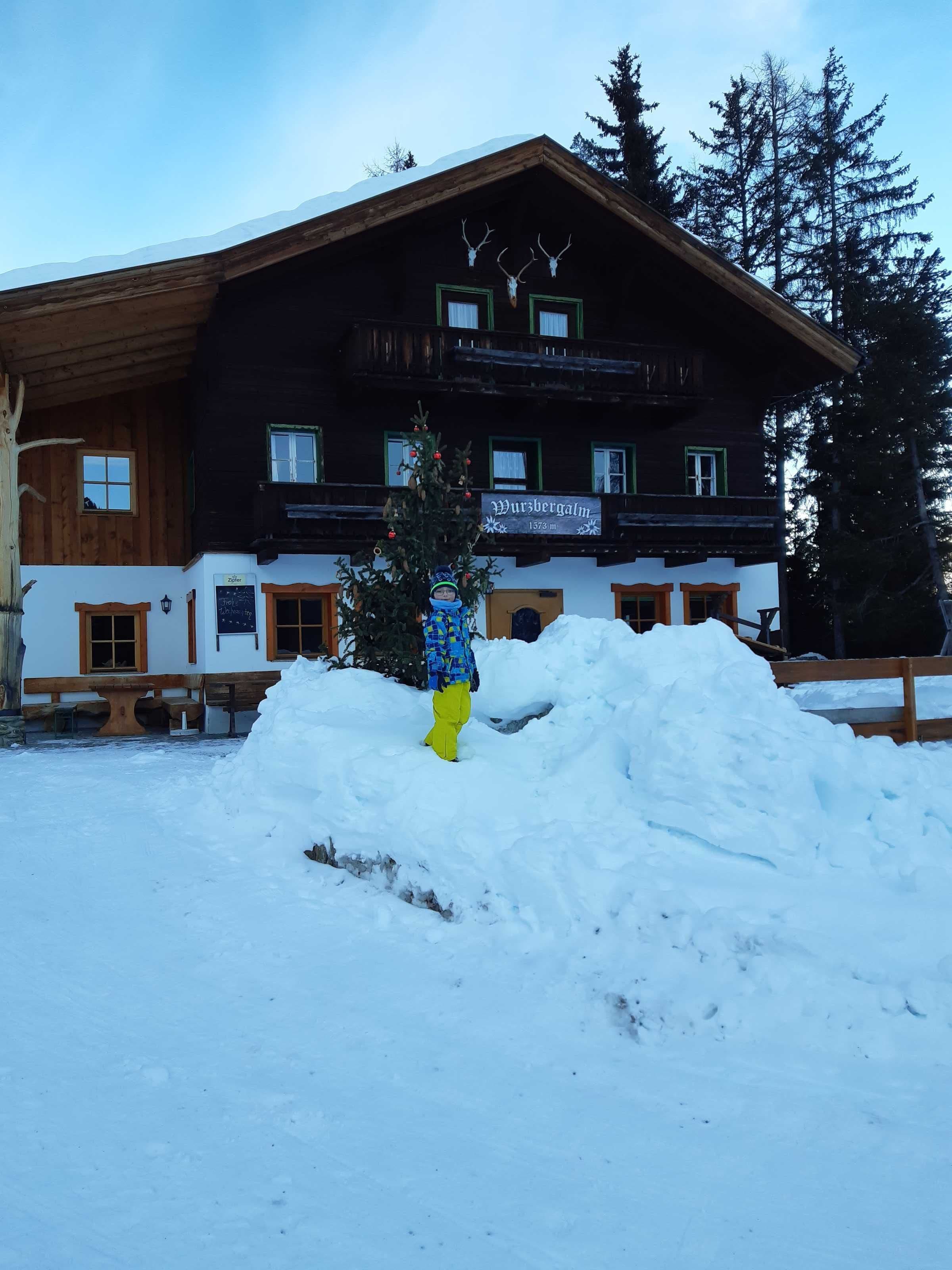 A wooden building with a sign reading 'Wursbergalm 1378 m.'