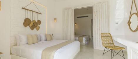 A spacious bedroom with a large bed, a chair, and a mirror.