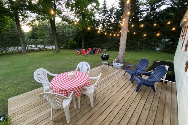 Front deck with seating and a Weber charcoal smoke grill