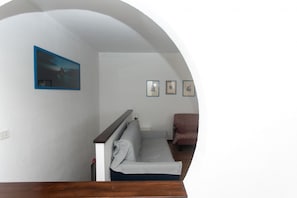 A room with a sofa, a chair, and a framed picture on the wall. - N232 - Numana, five-room apartment with garden in a residence with swimming pool (Numana)
