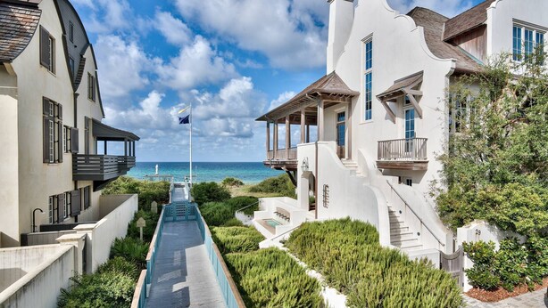 A modern resort with a pool, beachfront views, and a mix of architectural styles.