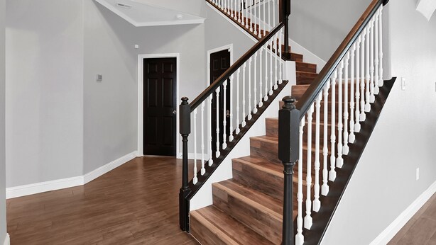 A staircase with wooden steps and white balusters, leading to an upper floor. - Stunning & Spacious home, 8 beds, PS4, Karaoke and lots more! (Spring)