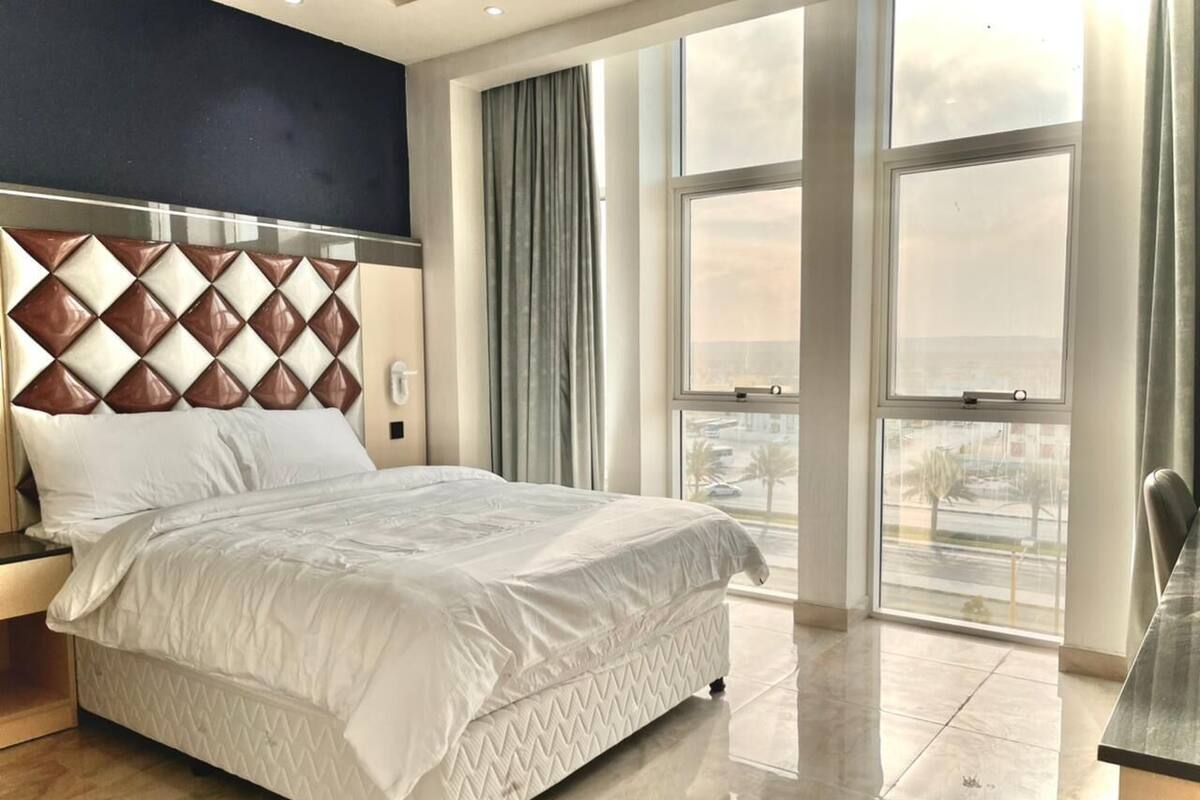Desk, laptop workspace, bed sheets