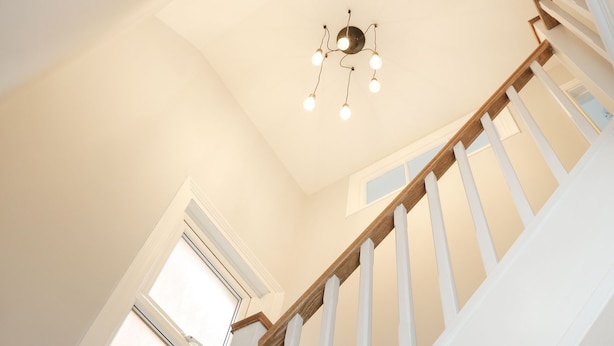 A staircase with white railings and wooden steps, leading to a room with a skylight and a chandelier. - 4 bed seaside let with parking
Central Broadstairs (Broadstairs)