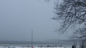 A snowy outdoor area with a bench, a railing, and a path leading to a body of water. - Bemus Point Lake Front Cottage with Dock (Bemus Point)
