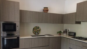 A modern kitchen with grey cabinetry, a built-in microwave, double ovens, and a gas stove. - Family house with arge garden - peaceful & close to Arcachon Bay - sleeps 6 (Gujan-Mestras)