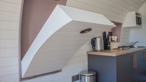 A modern kitchen with a built-in oven, a kettle, and a microwave. - Foxtail Glamping Pod - sleeps 2 | Gold Award winning (Pickering)