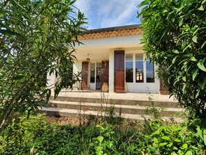 A house with a tiled roof, a front porch, and a large window. - Maison Familiale DE Vacances (Châteaurenard)