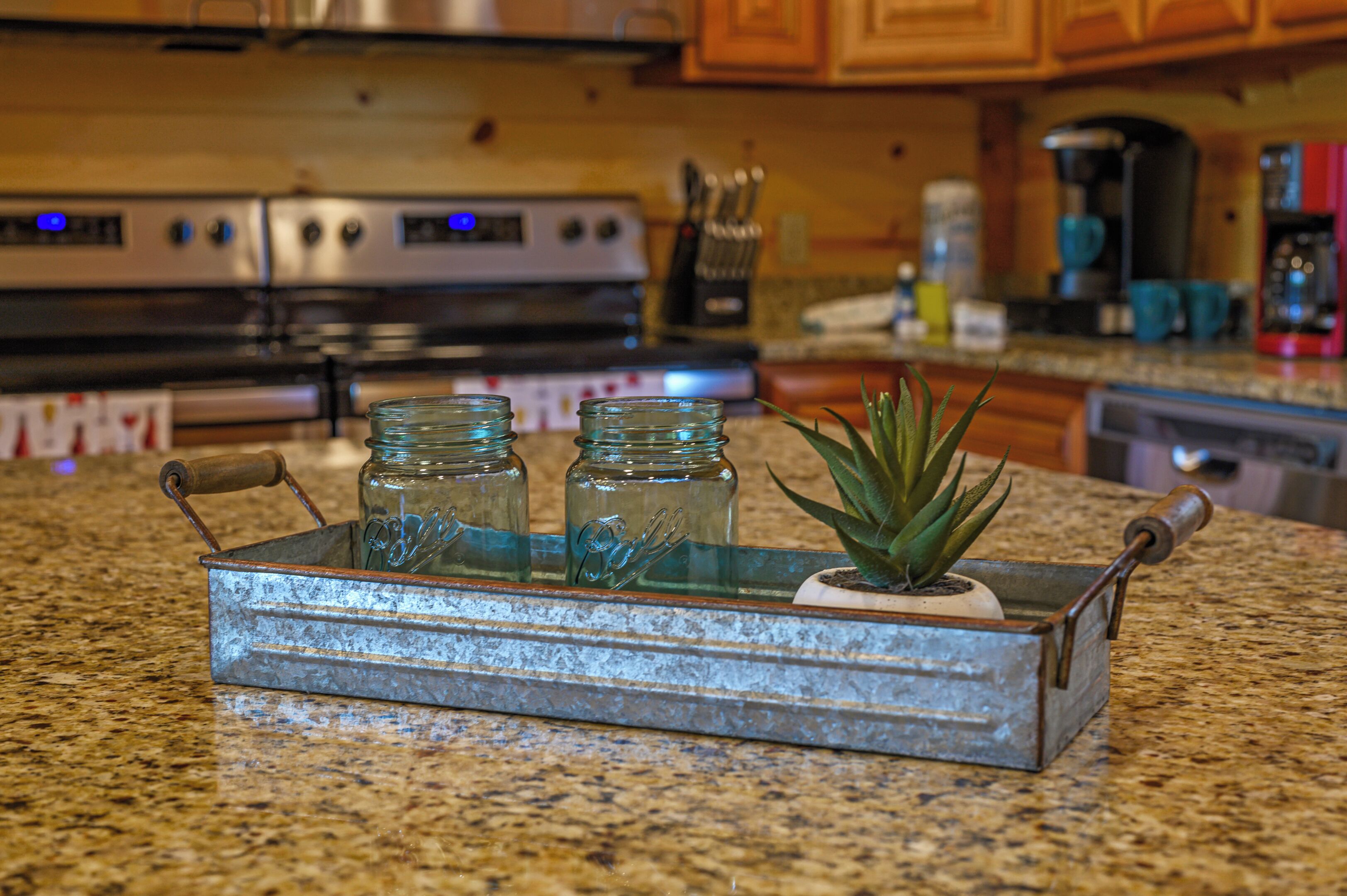 A kitchen with granite countertops, a stainless steel range, and wooden cabinets.