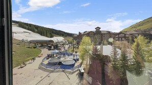 Une station de ski dotée d’un grand chalet, d’un télésiège et d’une plateforme d’observation circulaire.