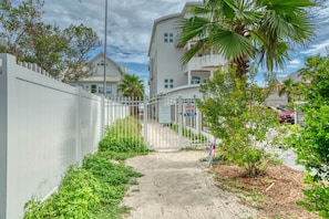 Stroll through the entrance to a serene residential area with access to the beach.