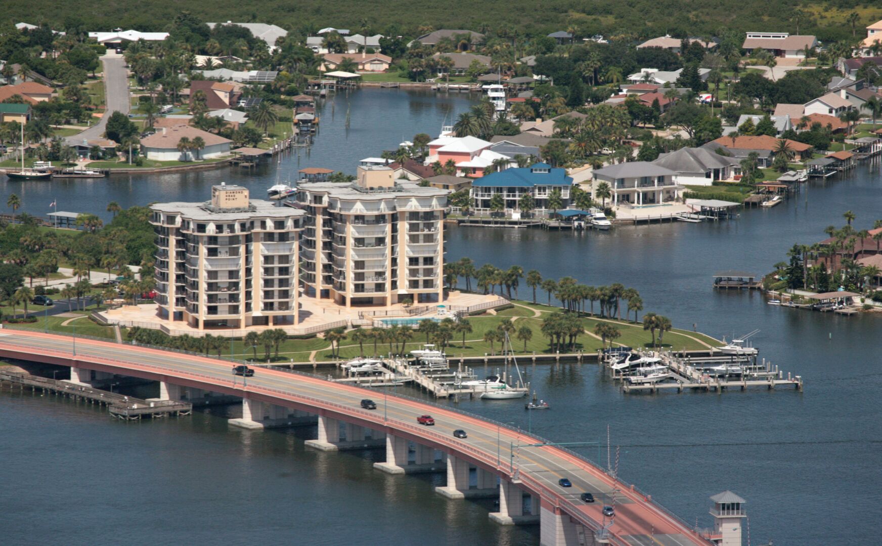 A multi-story hotel with a marina and a bridge.