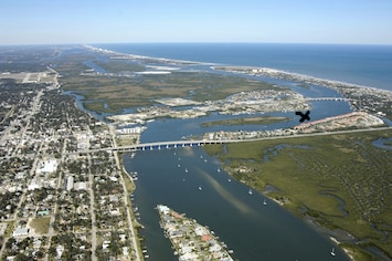 Beautiful New Smyrna Beach! The condos are on this side of X. Not on the water