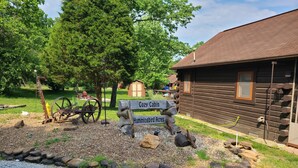 A rustic cabin with a wooden exterior and a gravel path leading to it. - COZY CABIN AT PATOKA LAKE(in happy hollow) (Birdseye)