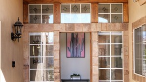 A spacious entryway with a stone floor, a bench, and a wall-mounted artwork. - Posh Villa Sleeps 12 w/ 4 bedroom, 3 bath Pool & Spa (Indio)