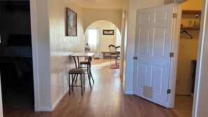 A hallway with a dining area, a door, and a ceiling light. - #6 Home in the Heart of Utah (Torrey)