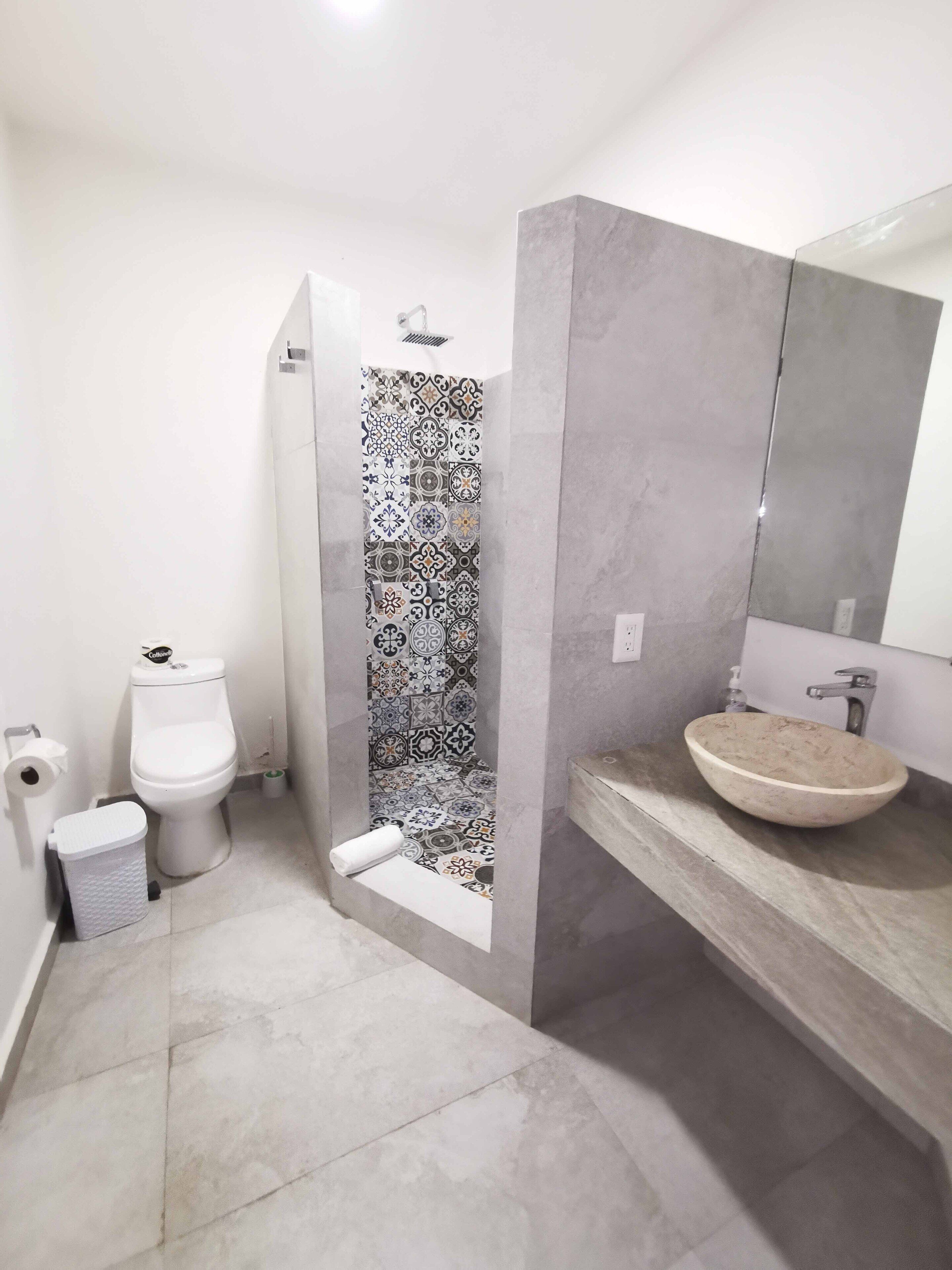 A bathroom with a toilet, bidet, and sink.