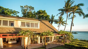 A modern house with a patio, large windows, and a view of the ocean. - Malaqereqere Ocean View, Villa 2 (Sigatoka)
