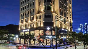 A multi-story hotel with a modern design, featuring illuminated signage and a prominent entrance. - AG405 Hotel (Busan)