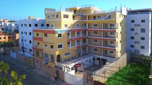 A multi-story hotel with balconies and a sign for 'Aparthotel'. - Room-single Room With Queen Bed Near SDQ (Santo Domingo Este)