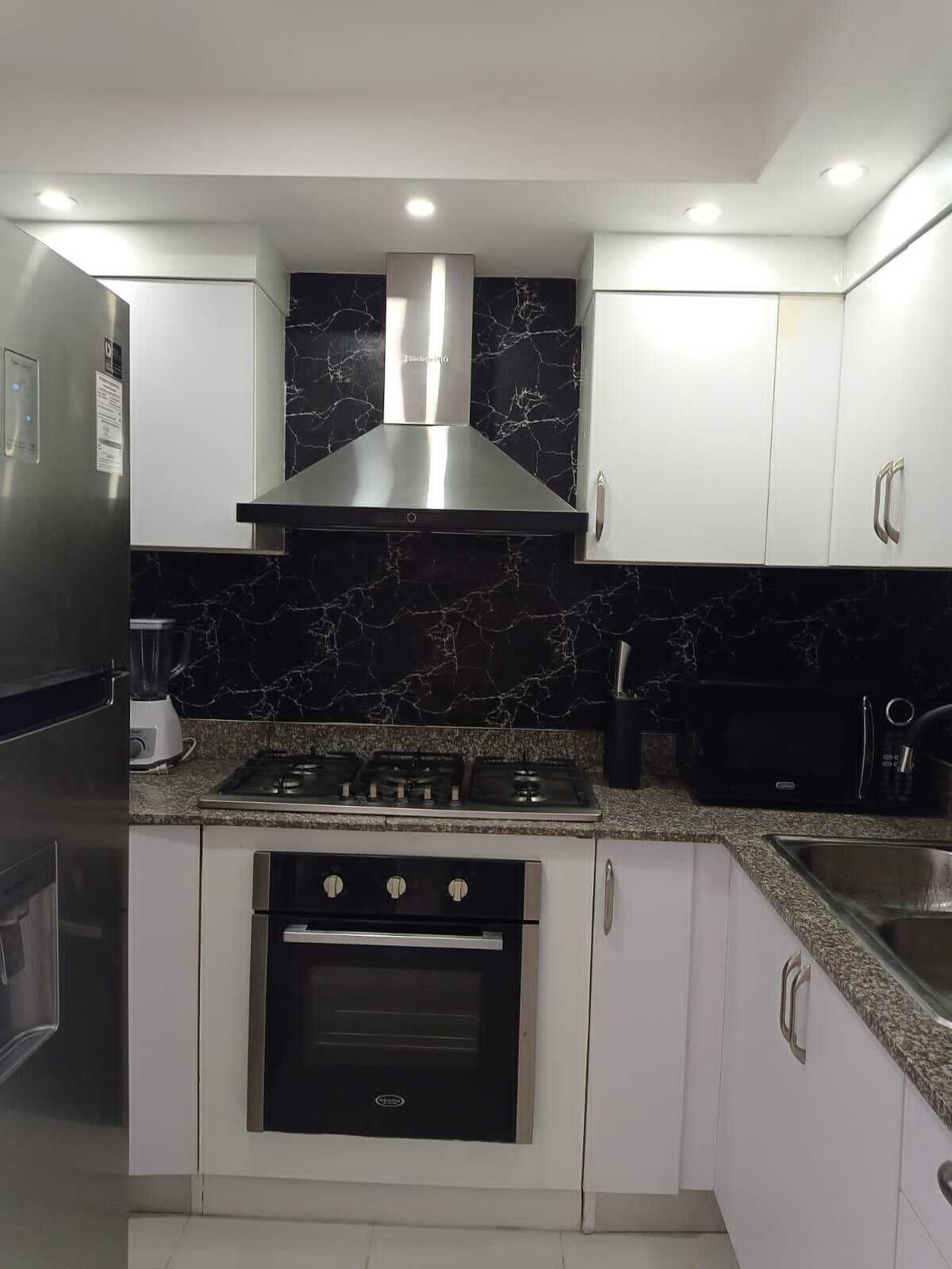 Stovetop, coffee/tea maker, cookware/dishes/utensils, dining tables