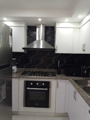 Stovetop, coffee/tea maker, cookware/dishes/utensils, dining tables - Luxurious Apartment 4to Level With Security Camera (Santo Domingo Norte)