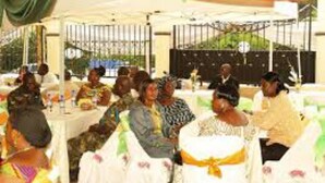 A tented event space with round tables, white tablecloths, and guests seated. - Luxurious Sunset Hotel in Kumasi (Kumasi)
