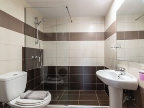 A bathroom with a toilet, bidet, and shower. - Phoenix Apartments - Alpha1 (Zakynthos)