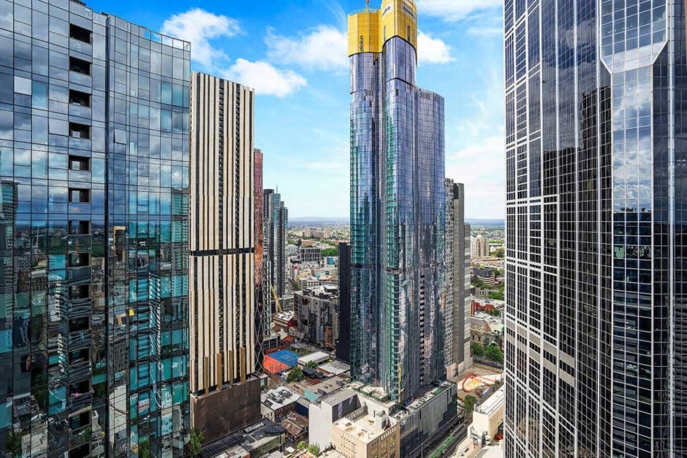 A high-rise urban area with modern glass buildings, some with vertical lines and others with a more traditional rectangular shape.